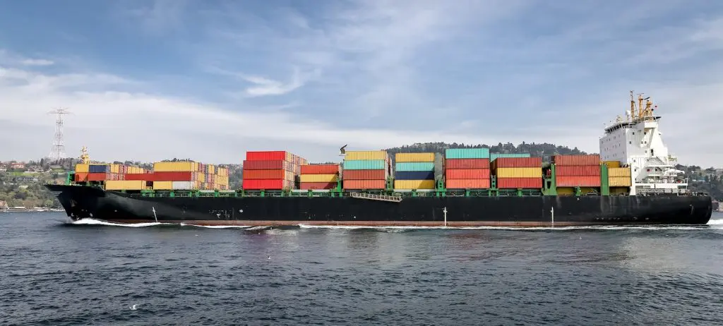 Cargo ship loaded with containers, illustrating the concept of international sea freight services provided by slg logistics.