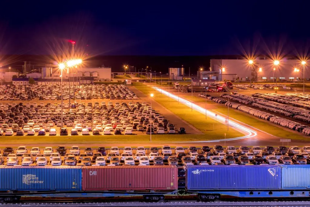 Cars parked in a port compound, ready for export from the uk to southeast asia, highlighting slg logistics' vehicle shipping services