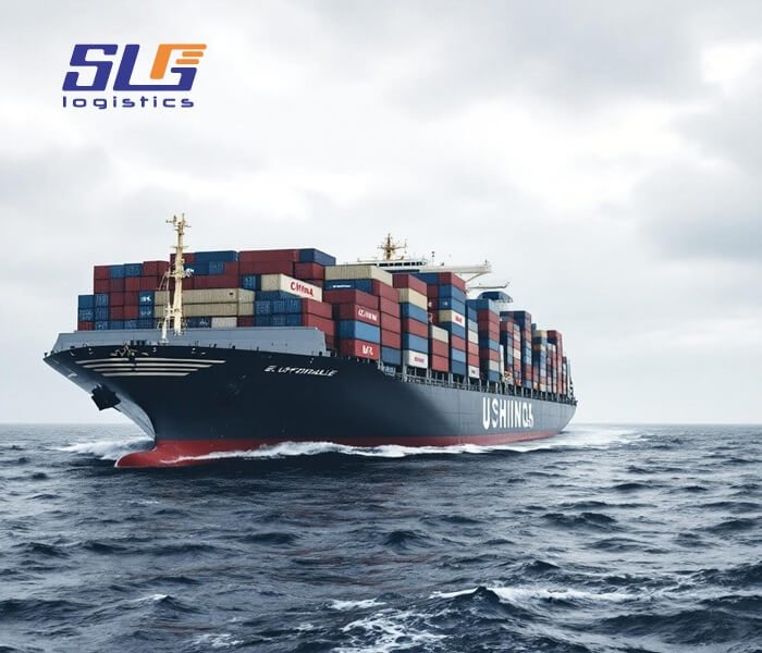 A large container ship loaded with multicolored shipping containers sails through choppy ocean waters under a cloudy sky. The vessel is on the hull, with various shipping line logos visible on the containers. The "SLG Logistics" logo appears in the top left corner.